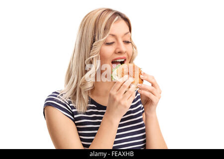 Studio shot di una gioiosa giovane donna di mangiare un panino isolati su sfondo bianco Foto Stock