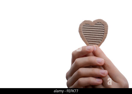 Cuore isolato di forma foro attraverso il cartone in mano Foto Stock