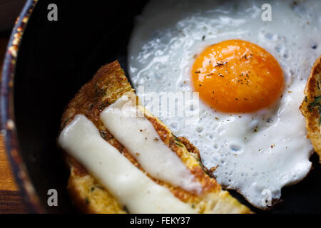 Uova fritte e pane con formaggio sul pan Foto Stock