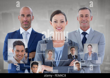 Immagine composita di colleghi d'affari sorridente in telecamera Foto Stock