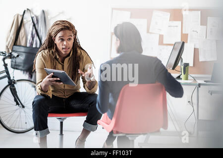 La gente di affari di parlare in ufficio Foto Stock