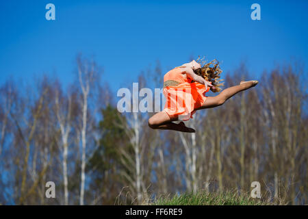 Ginnasta giovani facendo esercizi in una foresta a primavera tempo Foto Stock