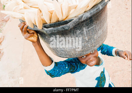 Mali, Africa - i giovani portano il cibo, i cereali in un villaggio vicino a Bamako Foto Stock