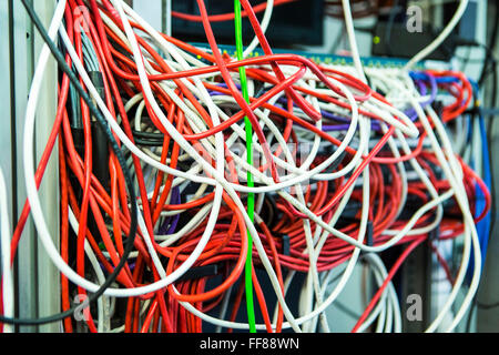 Una grande massa di multi-colore dei cavi del computer in una sala server in un British business office di Londra, Regno Unito. Foto Stock