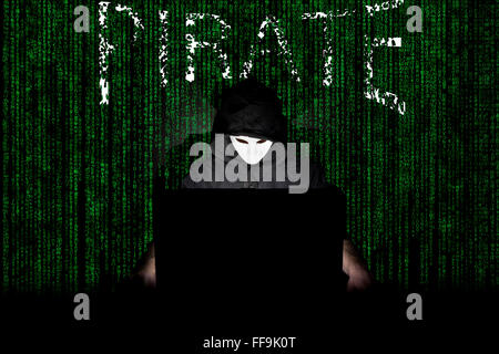 Un uomo mascherato in un laptop che simboleggia i pericoli di Internet. Foto Stock