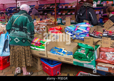 Una signora anziana shopping a buon cibo e masserizie in stallo il mercato settimanale in redcar cleveland North Yorkshire Regno Unito Foto Stock