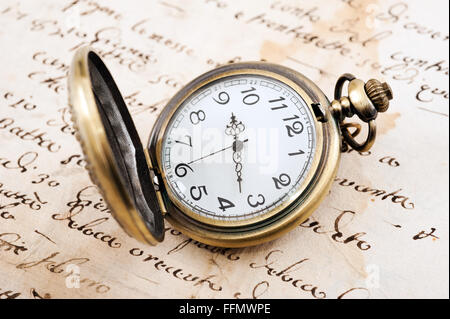 Vintage orologio da tasca su sfondo manoscritto Foto Stock