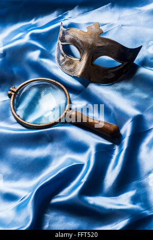 Maschera e un vintage lente di ingrandimento Foto Stock