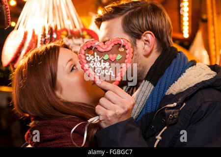 Giovane e gingerbread cuore "ti amo" in tedesco Foto Stock