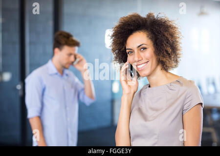 Giovane donna comunicanti sul telefono cellulare Foto Stock
