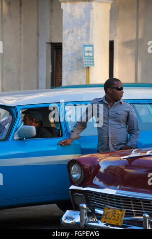 La vita quotidiana a Cuba - uomini cubano e vecchie auto a l'Avana, Cuba, West Indies, dei Caraibi e America centrale Foto Stock