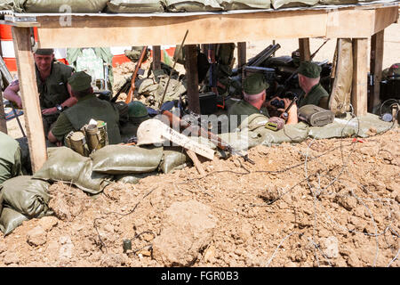 Guerra e Pace show, Inghilterra. Guerra del Vietnam rievocazione del comando americano bunker con tetto. Molti marines all'interno rilassante, una holding binocolo. Foto Stock