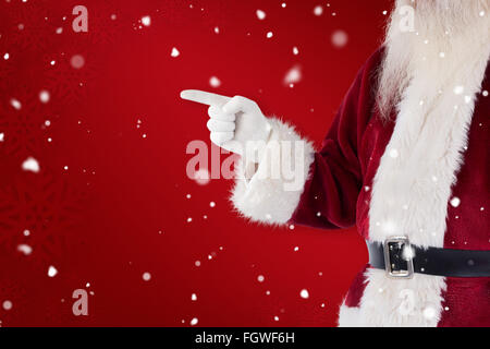 Immagine composita di santa claus punti a qualcosa di Foto Stock