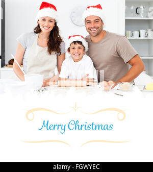 Immagine composita del ritratto di una famiglia felice la preparazione di biscotti di Natale Foto Stock