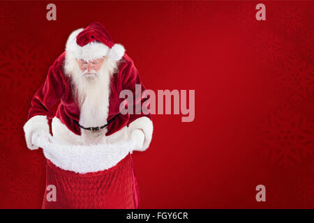 Immagine composita di santa guarda nella sua borsa Foto Stock