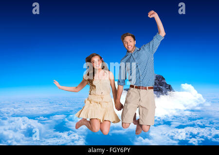 Immagine composita di allegro coppia giovane jumping Foto Stock