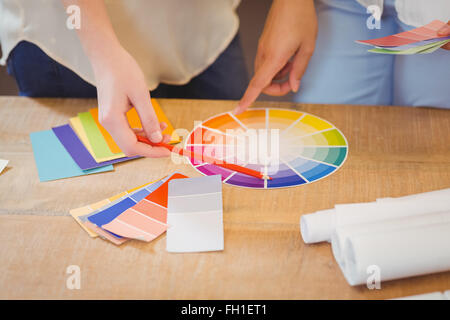 I colleghi rivolta verso i diagrammi di flusso Foto Stock