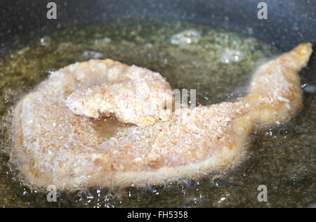 Scaloppina di pollo frittura in padella con olio di oliva Foto Stock