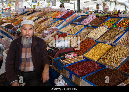 Bishkek, Kirghizistan - Ottobre 2, 2014: una frutta secca fornitore con il suo negozio al bazar di SSL Foto Stock