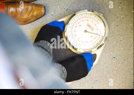 Paziente in piedi sulle scale durante un controllo medico presso il locale NHS centro salute Foto Stock