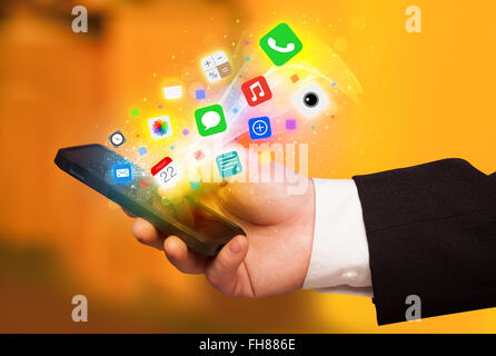 Mano azienda smartphone con colorate le icone delle app Foto Stock