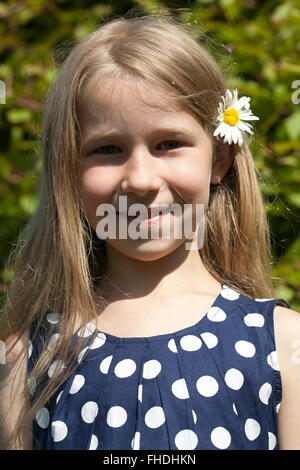Bambina ritratto con fiori di camomilla per i capelli Foto Stock