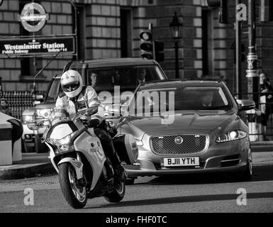 Scorta di polizia per il ministro del governo in viaggio da 10 Downing Street al Parlamento lungo Whitehall Foto Stock