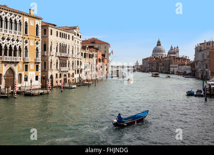 Trafficato Canal Grande con molto traffico, Venezia, e la Basilica di Santa Maria della Salute dal Ponte dell'Accademia, Venezia, Italia, sotto un cielo blu Foto Stock