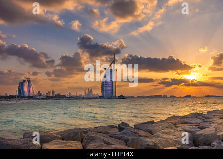 Dubai, Emirati Arabi Uniti - 2 dic. 2014 : Gli Illuminati di Burj Al Arab e la Jumeirah Beach Hotel al tramonto. Il Burj Al Arab è Foto Stock