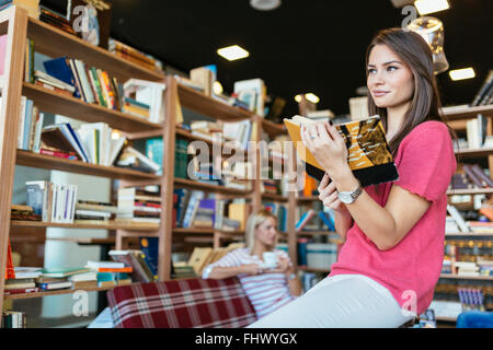 Intellettuali studenti la lettura di libri in biblioteca Foto Stock