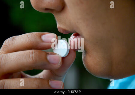 Donna Thai malato e medicina di mangiare prima del riposo Foto Stock