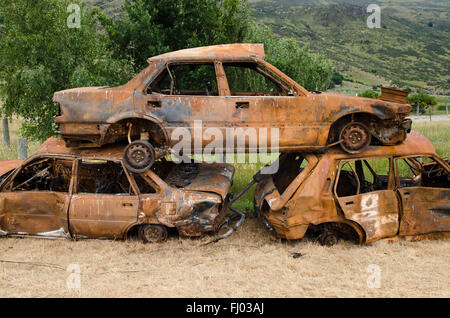 Pila di tre rusty auto rottamate, auto cimitero, Isola del Sud, Nuova Zelanda Foto Stock