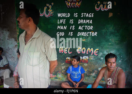 Citazione di Shakespeare ispirazioni sulla parete di Kolkata, la nuova area di mercato con gli uomini indiani intorno , in attesa per il bus Foto Stock
