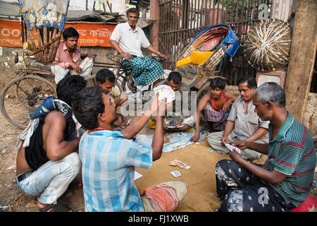 In rickshaw driver hanno una pausa e giocare a carte in area Sadarghat , Dhaka , Bangladesh Foto Stock