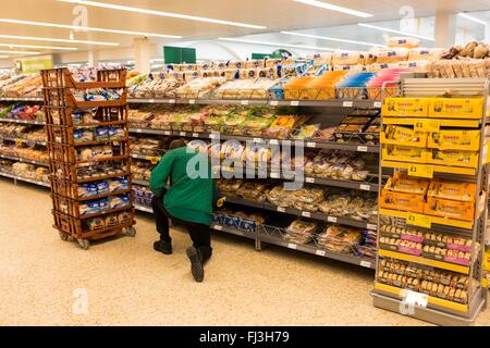 Un uomo lavora nella panetteria sezione di Morrisons supermercato Foto Stock