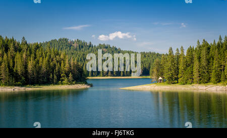 Piccola casa in legno al mountain lake shore. Foto Stock