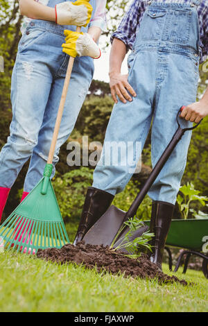 Coppia giovane stare vicino a un alberello in giardino Foto Stock