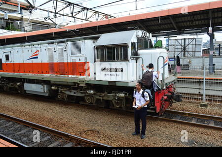 Treno a vapore conducente guardando fuori la sua cabina in Jakarta, Indonesia Foto Stock