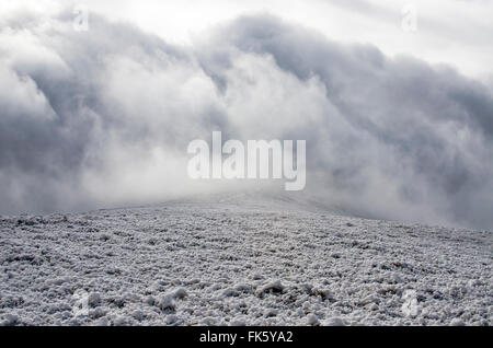 Percorso in inverno nuvole temporalesche in montagna Foto Stock