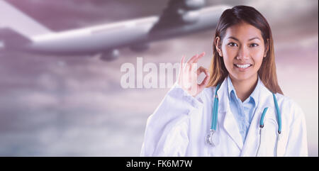 Immagine composita di asian medico facendo segno ok Foto Stock