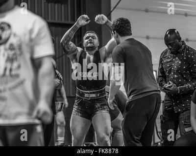 Fotografia documentaria dalla potenza di un evento di sollevamento dotata di uomini deadlifting e panca premendo e vivendo il trionfo e lo stress Foto Stock