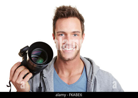 Felice fotografo tenendo la fotocamera digitale con trigger remoto Foto Stock