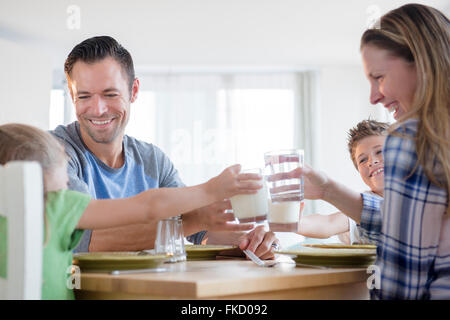 Famiglia con due bambini (6-7, 8-9) facendo un toast Foto Stock