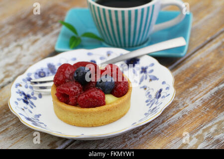 La crema torta con crema pasticcera e fragole fresche e mirtilli sulla piastra vintage Foto Stock