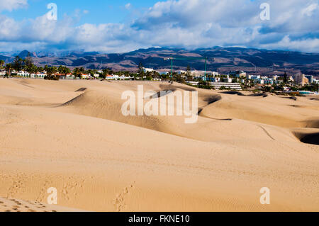 Vista sulla soleggiata dune di Maspalomas in Gran Canaria nelle ore diurne. Cielo nuvoloso sullo sfondo. Foto Stock