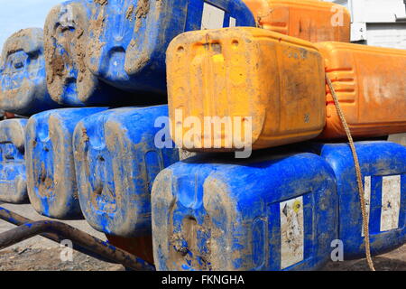 Big blu-giallo i bidoni di plastica-vuoto e impilati su un ferro da stiro carriola collocato sulla principale strada unica della città Afrera-Danakil Foto Stock