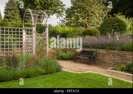 Recentemente progettata e paesaggistici, una bella e tradizionale giardino con pergolato e frontiere, in estate - Burley in Wharfedale, West Yorkshire, Inghilterra. Foto Stock