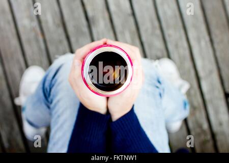Donna che mantiene le bevande pallone, ad alto angolo di visione Foto Stock
