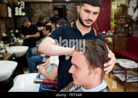 Parrucchiere in Barberia il taglio di giovani mans capelli Foto Stock