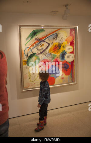 Museo Guggenheim interno, progettato da Frank Lloyd Wright. Della Città di NY. Ragazzo giovane controlla una coloratissima Kandinsky pittura. Foto Stock